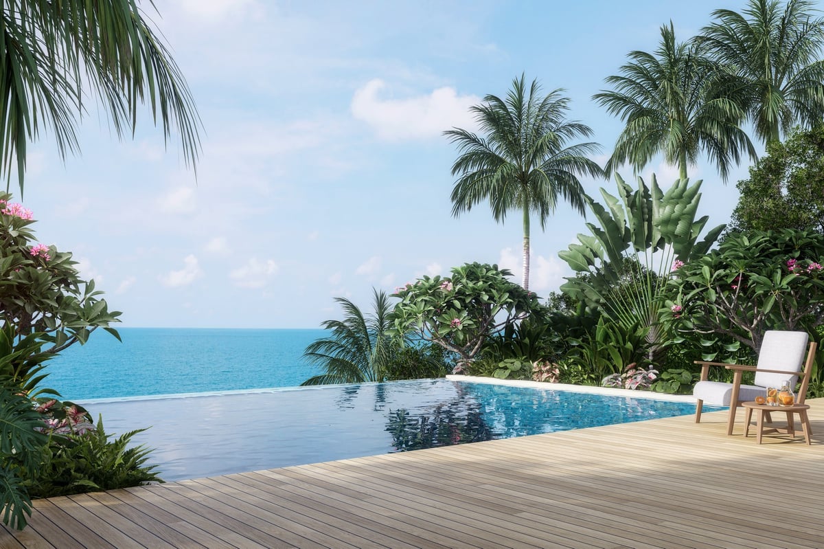 Luxury pool terrace with sea view surrounded by tropical garden