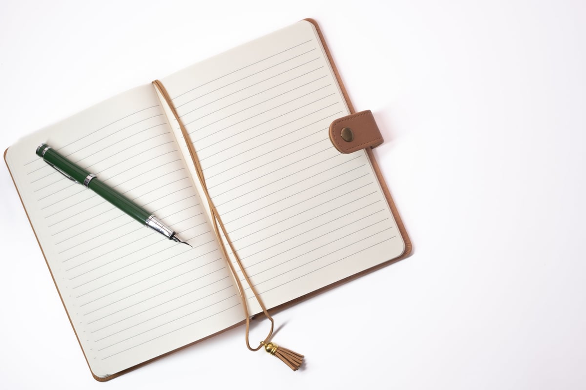 An open notebook with a pen on it, ready for planning